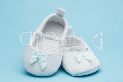 Baby booties with blue ribbon