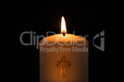 Candle with cross embellishment