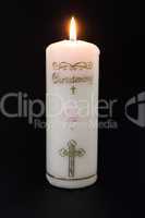 Lit white christening candle with pink detail