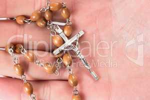 Rosary beads in someones hand