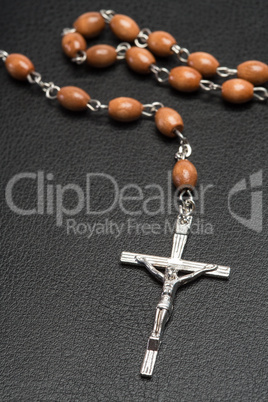 Rosary beads resting on a bible