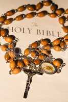 Rosary beads on page of bible