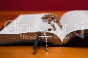 Rosary beads resting on open bible