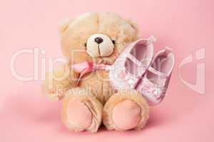 Fluffy teddy with pink ribbon and baby booties