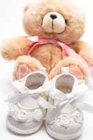 Teddy bear for a girl with white baby booties