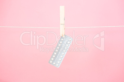 Contraceptive pill blister pack hanging from line