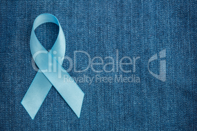 Blue ribbon for prostate cancer awareness on demin with copyspac
