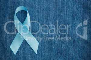 Blue ribbon for prostate cancer awareness on demin with copyspac