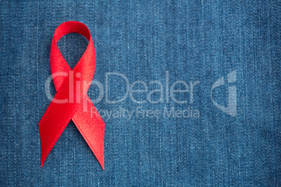 Red ribbon for aids awareness on denim