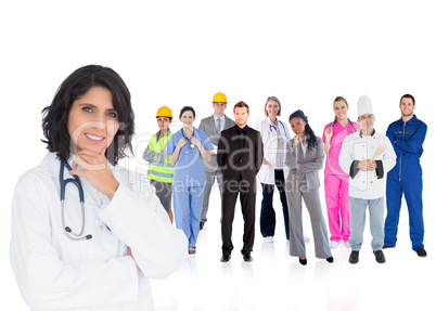 Doctor smiling with various workers behind her
