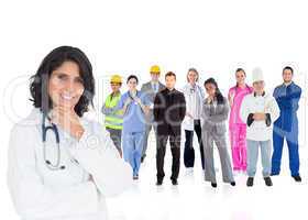 Doctor smiling with various workers behind her