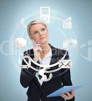 Thoughtful businesswoman with tablet pc considering applications
