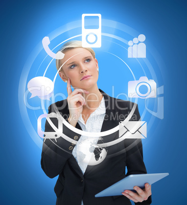 Businesswoman with tablet pc considering various applications