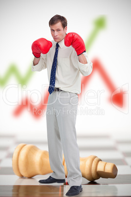 Businessman in boxing gloves on chessboard