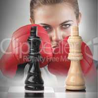 Female boxer behind the chess board