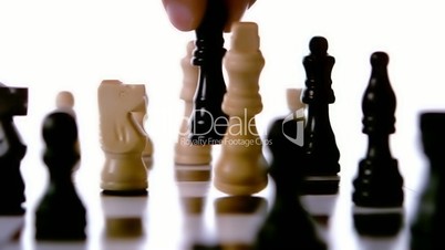 Black chess piece knocking over white