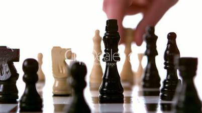 White chess piece knocking black king