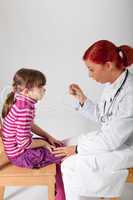 Die Kinderärztin hat ein Fieberthermometer in der Hand