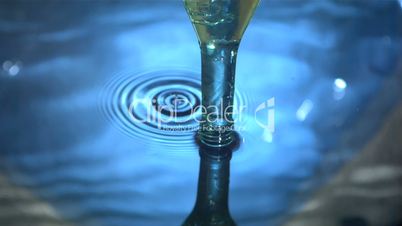 Glass bottle coming out of water pool