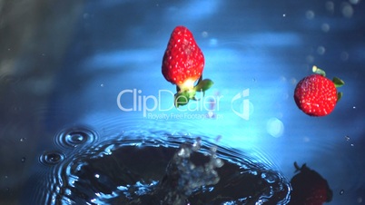 Strawberries falling into water