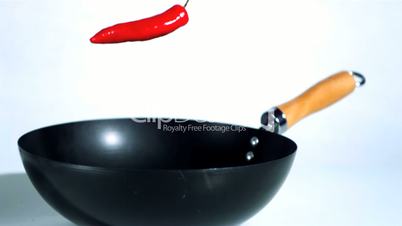 Red chili falling into wok