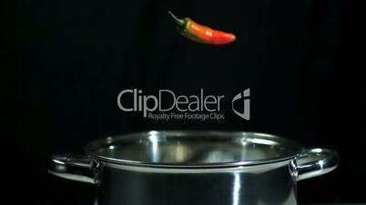 Red chili corn cob and tomatoes falling into pot