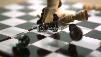 Chess pieces crashing onto board