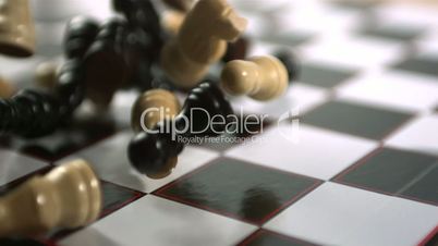 Chess pieces crashing on board