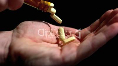 Large pills being poured into hand