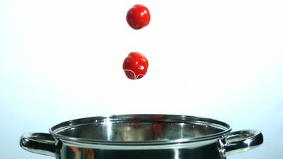 Cherry tomatoes falling in a pot