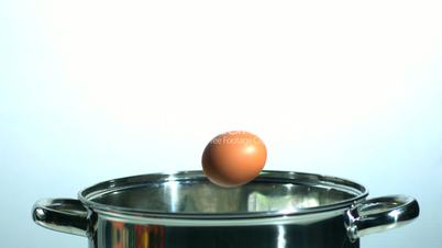 Egg falling in a pot