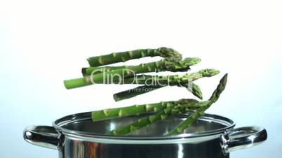 Asparagus falling into a saucepan