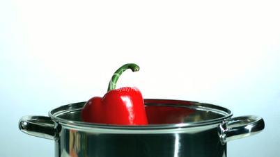 Red pepper falling in saucepan
