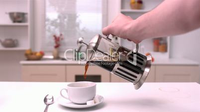 Coffee being poured in the kitchen