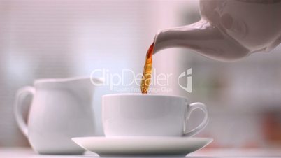 Teapot pouring tea