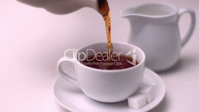 Tea pouring into tea cup