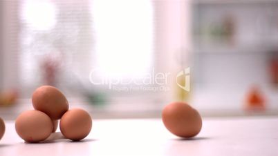 Egg smashing beside pile of eggs