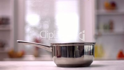 Tagliatelle falling in pot in kitchen