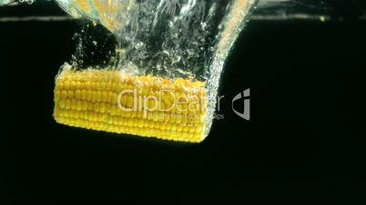 Corn cob falling in water