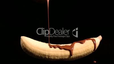 Melted chocolate pouring over a banana