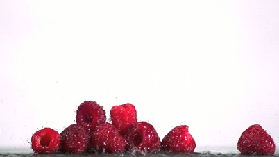 Water falling on raspberries