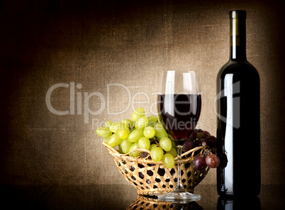 Grapes and a bottle with wine