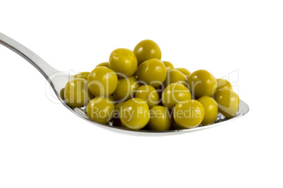 Canned green peas in a spoon