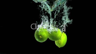 Three limes falling into water