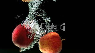 Apples falling in water