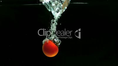 One tomato falling in water