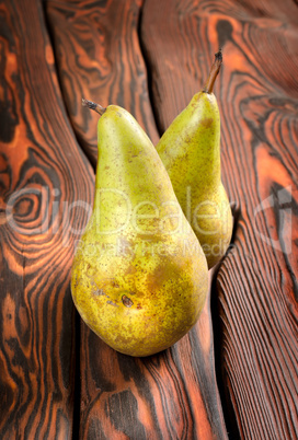 Two pears on an old wooden background