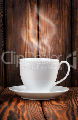 White cup with steaming hot drink