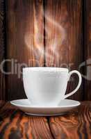 White cup with steaming hot drink