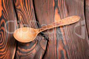 Wooden spoon on the wooden background